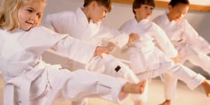 Kids learning martial art techniques